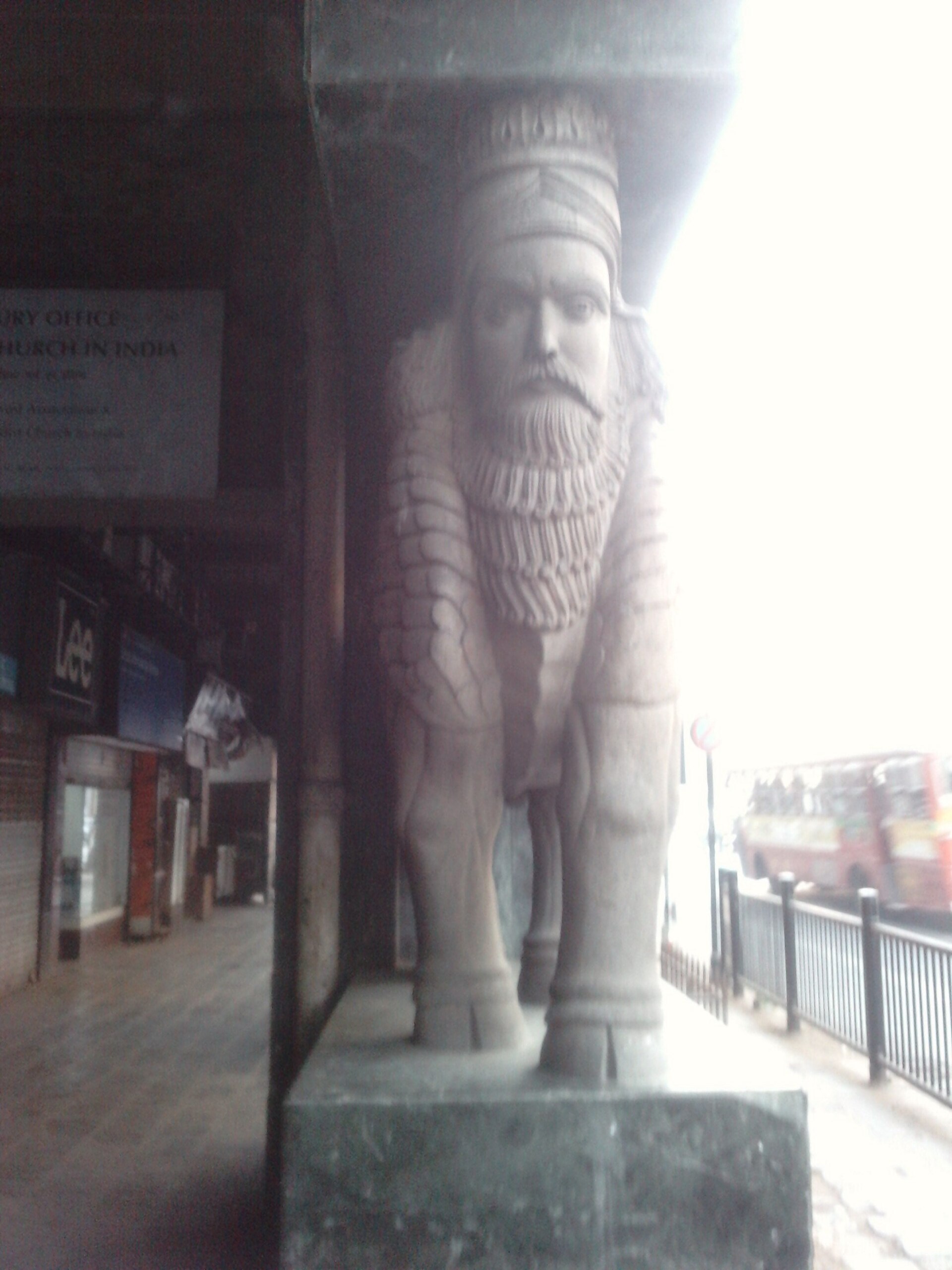 Dhansak | The India A stone statue of a bearded figure with a turban stands outdoors, representing the cultural heritage connected to Dhansak.